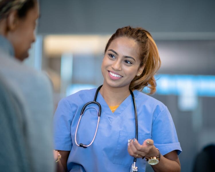 friendly registered nurse speaking to a doctor