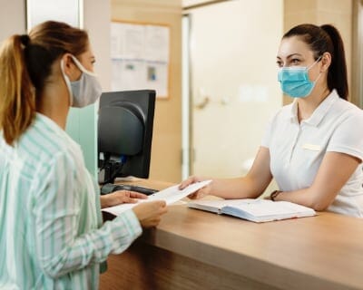 patient paying bill in doctor's office